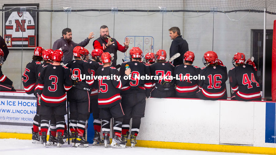 Players gather close to listen to the coach. Husker Hockey at Breslow Ice Hockey Center. October 7, 2023. Photo by Dillon Galloway for University Communication and Marketing.