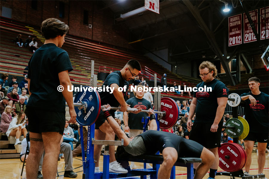 David Ho, Junior, giving a lift off for athlete Dax Duncan, freshman, during the bench event in the Strong Husker Powerlifting meet held in the Coliseum, hosted by UNL Barbell Club. October 7, 2023. Photo by Jonah Tran / University Communication