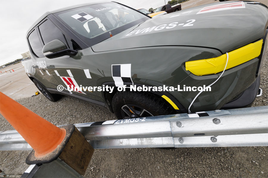 The Rivian is parked against the guard rail at the angle it will hit during the crash. In research sponsored by the U.S. Army Engineer Research and Development Center, the University of Nebraska-Lincoln’s Midwest Roadside Safety Facility is investigating the safety and military defense questions raised by the burgeoning number of electric vehicles on the nation’s roadways. crash test performed on a guardrail on October 12, 2023, highlighted the concern. At 60 mph, the 7,000-plus-pound, 2022 Rivian R1T truck tore through a commonly used guardrail system with little reduction in speed. October 12, 2023. Photo by Craig Chandler / University Communication and Marketing.