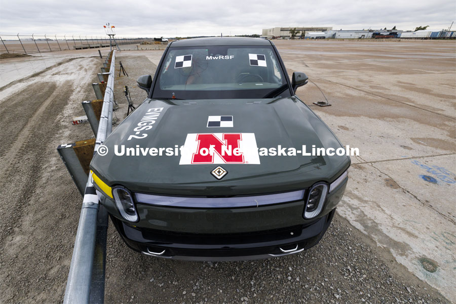 The Rivian truck has decals affixed to the sides and top to make it easier for the data to be used that the cameras capture. In research sponsored by the U.S. Army Engineer Research and Development Center, the University of Nebraska-Lincoln’s Midwest Roadside Safety Facility is investigating the safety and military defense questions raised by the burgeoning number of electric vehicles on the nation’s roadways. crash test performed on a guardrail on October 12, 2023, highlighted the concern. At 60 mph, the 7,000-plus-pound, 2022 Rivian R1T truck tore through a commonly used guardrail system with little reduction in speed. October 12, 2023. Photo by Craig Chandler / University Communication and Marketing.