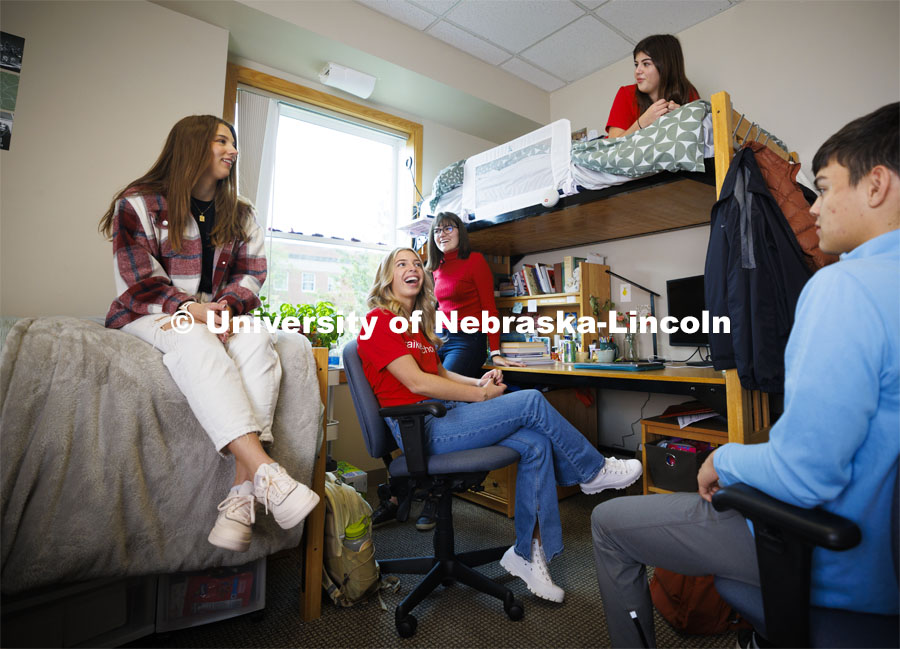 Students hangout together in a  Kauffman Academic Center dorm room. Raikes School photo shoot. October 18, 2023. Photo by Craig Chandler / University Communication.