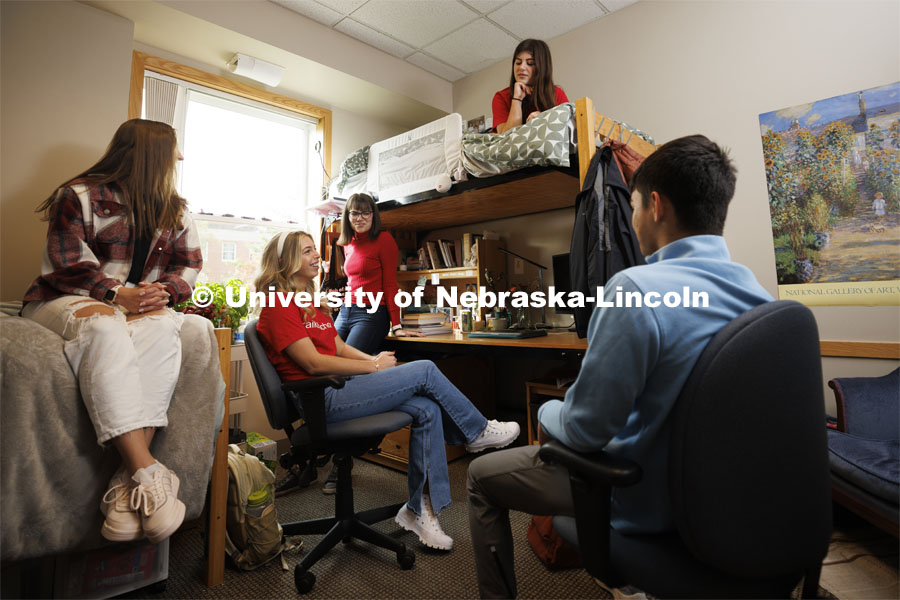 Students hangout together in a  Kauffman Academic Center dorm room. Raikes School photo shoot. October 18, 2023. Photo by Craig Chandler / University Communication.