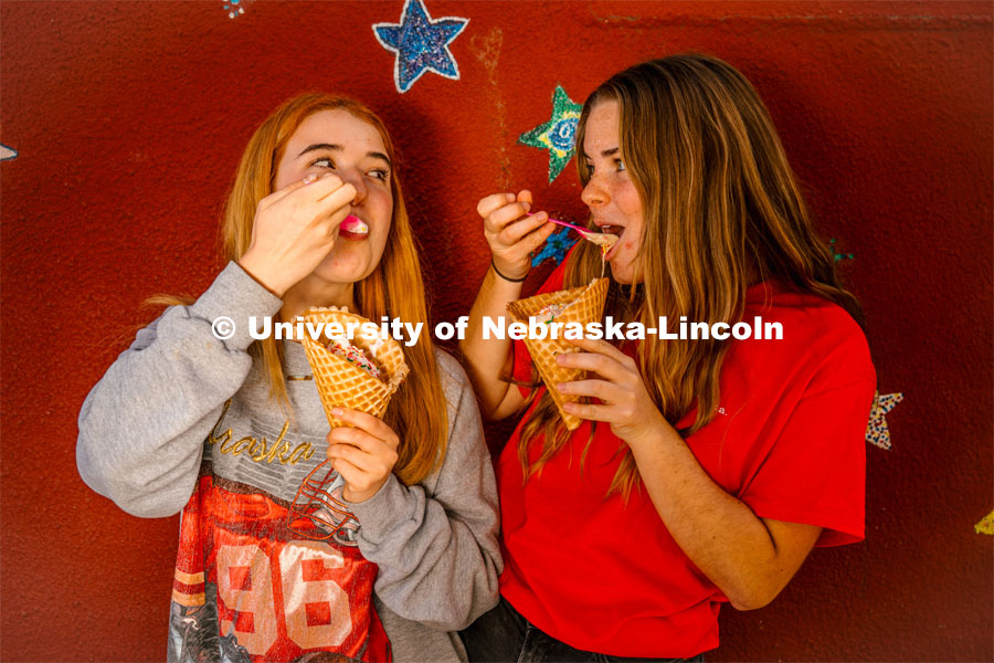 Hannah-Kate Kinney and Cora Scott enjoy waffle cones at Ivanna Cone. About Lincoln at Ivanna Cone in the Haymarket. October 20, 2023. Photo by Matthew Strasburger / University Communication.