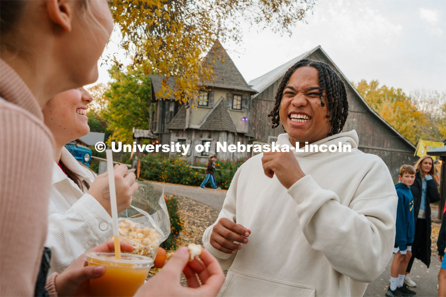 Amani Mfinanga laughs with fellow Cheer Squad members at Roca Berry Farms. About Lincoln at Roca Berry Farm. October 22, 2023. Photo by Matthew Strasburger / University Communication.