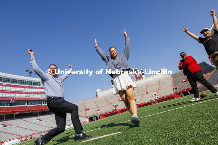 Kristen Labadie kicks a field goal on the hold by Brandon Meier during the birthday party. Memorial Stadium 100th birthday party at the stadium. The free public event featured cake and visitors could walk onto the field. October 23, 2023. Photo by Craig Chandler / University Communication.