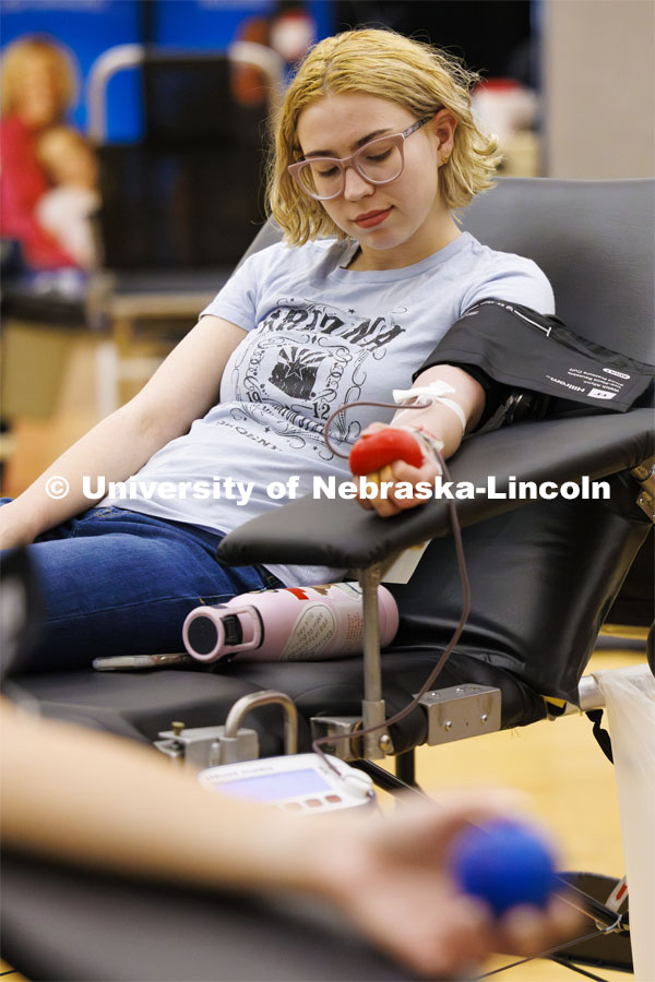 Madeline Stoerp squeezes a ball to help the blood flow while donating. Homecoming blood drive. Homecoming Week 2023. October 24, 2023. Photo by Craig Chandler / University Communication.