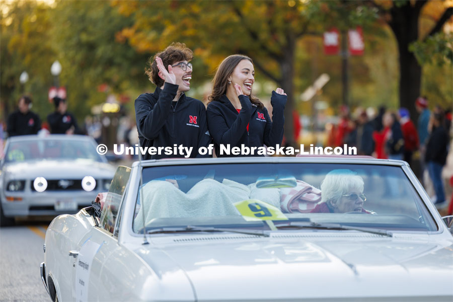 Homecoming royalty candidates Sam Spethman and Lydia Storm wave to the crowd along the parade route. Homecoming parade and Cornstock. October 27, 2023. Photo by Craig Chandler / University Communication.