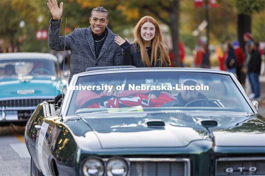 Homecoming royalty candidates Samuel Phillips and Hannah-Kate Kinney wave to the crowd along the parade route. Homecoming parade and Cornstock. October 27, 2023. Photo by Craig Chandler / University Communication.