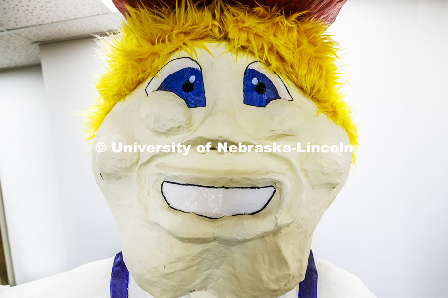 Ashley Dohe, Administrative Coordinator for Electrical and Computer Engineering, has made an 8-foot tall Herbie Husker from paper- mâché. She hopes to auction it off to help veterans. October 30, 2023. Photo by Craig Chandler / University Communication.