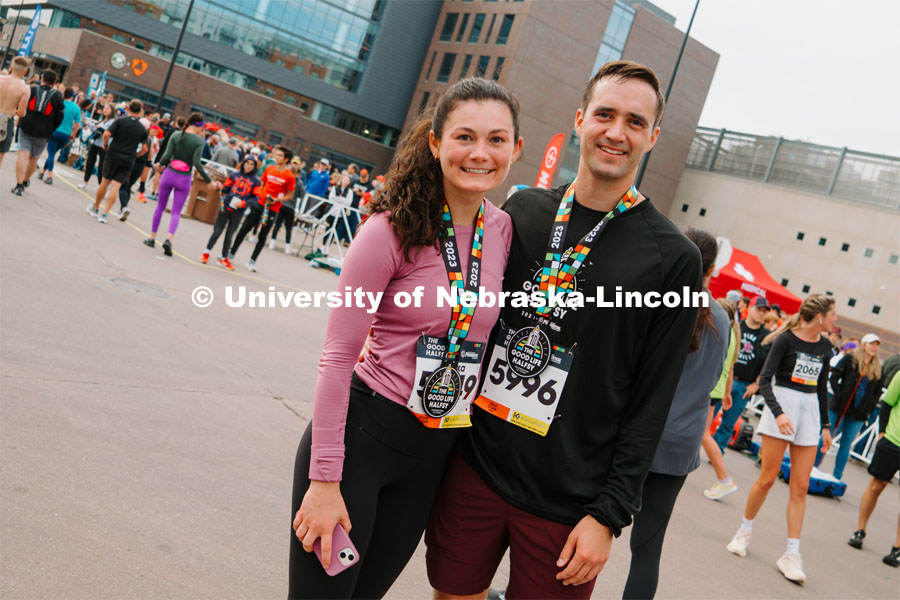 Runners pose for a picture with their medals. The Good Life Halfsy half marathon runs through the streets of Lincoln and end downtown in the Haymarket. About Lincoln at the Good Life Halfsy. November 5, 2023. Photo by Matthew Strasburger / University Communication.