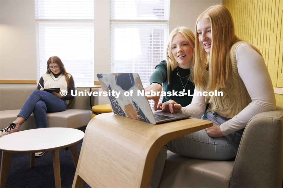 Madalyn Schoneman, center, and Alexis Tenorio look over work on the laptop as Sarah Danahy studies in the Knoll Residential Center lounge. A University of Nebraska–Lincoln team’s proposed renovation of a little-used TV lounge in the Robert E. Knoll Residential Center features multiple study spaces designed to allow for collaboration between students won the 2019 Big Ten Academic Alliance Student Design Challenge. Following pandemic delays, the furniture has been delivered. The annual contest, supported by the Herman Miller furniture company, allows students to develop and pitch a renovation of an existing campus space. November 17, 2023. Photo by Craig Chandler / University Communication and Marketing.