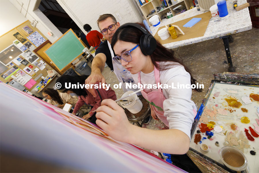 Sarah Preston, a sophomore from Gering, Nebraska, receives some color advice from Aaron Holz. Students work on their master study painting in Aaron Holz’ PANT 251: Beginning Painting course in Richards Hall. November 29, 2023. Photo by Craig Chandler / University Communication and Marketing.