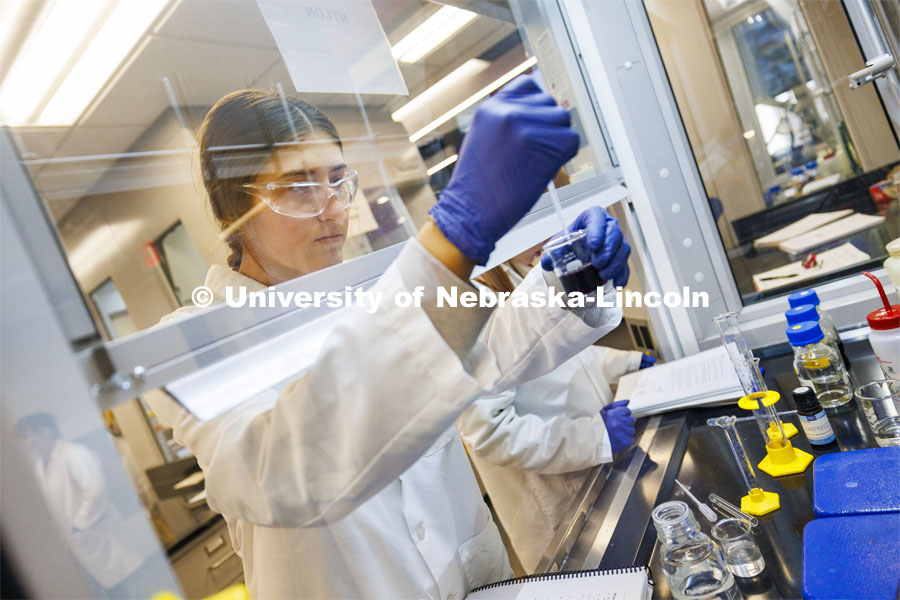 Kara Liebentritt, a sophomore from Omaha, measures chemicals to make nylon. Students in organic chemistry lab in Hamilton Hall. November 30, 2023. Photo by Craig Chandler / University Communication and Marketing.