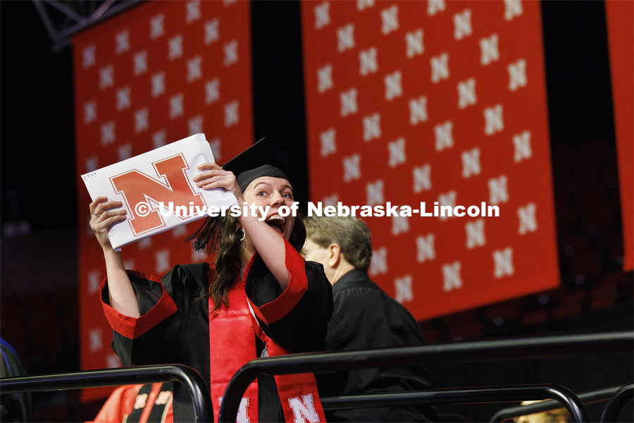 Danielle Wilcox shows off her diploma to family and friends Saturday morning. Winter undergraduate commencement in Pinnacle Bank Arena. December 16, 2023. Photo by Craig Chandler / University Communication and Marketing.