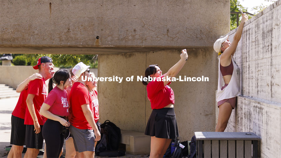 Sky Krull, right, and Gabrielle Brady takes selfies of the cymbal line during the Cornhusker Marching Band Camp first day of practice. August 15, 2024. Photo by Craig Chandler / University Communication and Marketing.