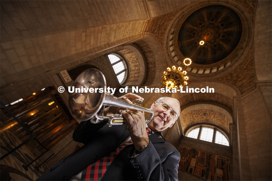 Nebraska State Senator Robert Clements (’73) was a trumpet player in the Cornhusker Marching Band and plays yearly with the alumni band. Clements is pictured in the State Capitol with his trumpet. Photo for Nebraska Alumni magazine. January 18, 2024. Photo by Craig Chandler / University Communication and Marketing.