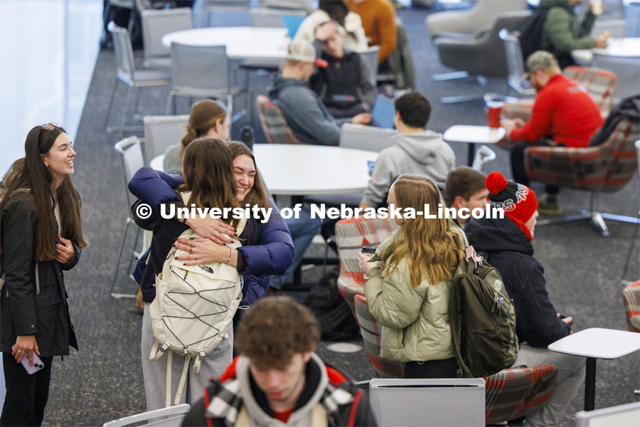 Anna Schuppel gives Riley Einspahr a hug as the friends talk in the East Commons of Kiewit Hall. First day of classes in Kiewit Hall. January 22, 2024. Photo by Craig Chandler / University Communication and Marketing.