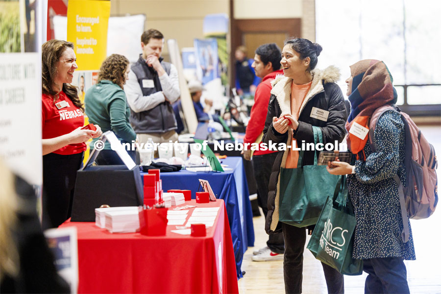Urmila Manandhar and Noshin Ara Tunazzina talk with recruiters from the Office of Research at the East Campus Career Fair. February 8, 2024. Photo by Craig Chandler / University Communication and Marketing.