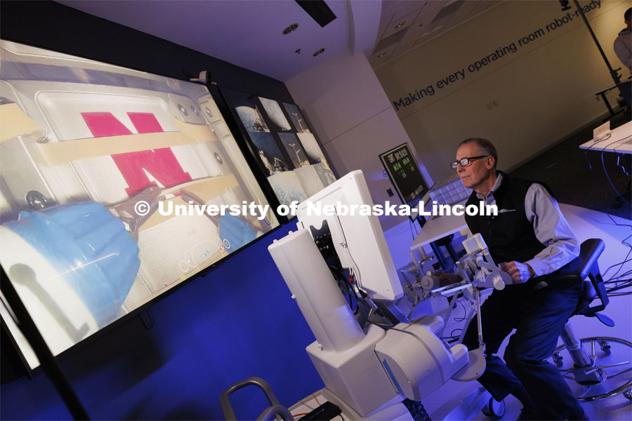 Dr. Gregory Heidrick smiles after making a successful cut while using the Space MIRA. Shane Farritor successfully performed robotic surgery on the International Space Station. Controlled from the Virtual Incision offices in Lincoln, NE, surgeons cut rubber bands–mimicking surgery–inside a payload box on the International Space Station. February 10, 2024. Photo by Craig Chandler / University Communication and Marketing.