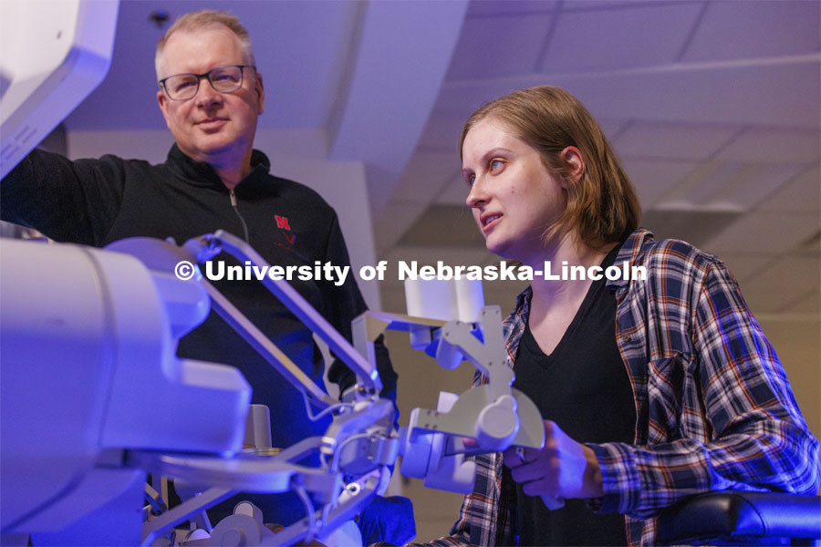 Rachael Wagner, a Husker doctoral student, gets a chance at surgically cutting a rubber band on the International Space Station as Nebraska Engineering professor and Virtual Incision founder Shane Farritor looks on. Virtual Incision successfully performed robotic surgery on the International Space Station. Controlled from the Virtual Incision offices in Lincoln, NE, surgeons cut rubber bands–mimicking surgery–inside a payload box on the International Space Station. February 10, 2024. Photo by Craig Chandler / University Communication and Marketing.