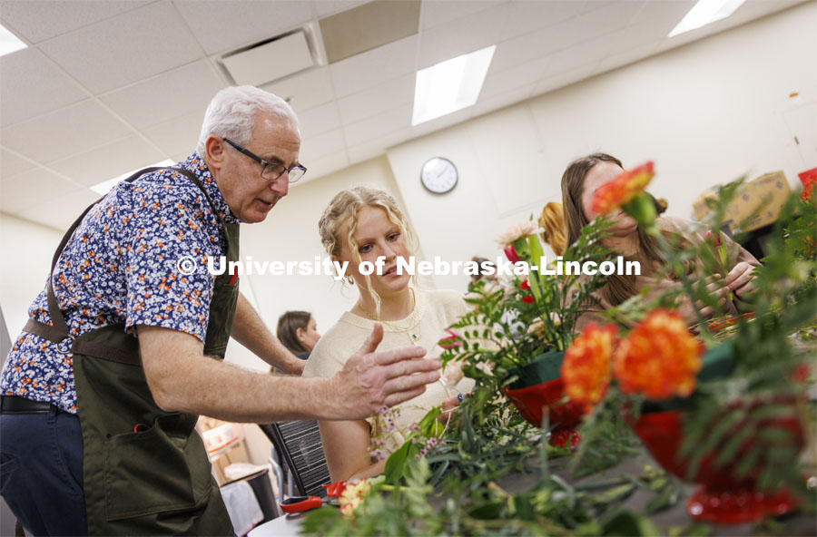 Professor Stacy Adams talks with Maddie Lind about adding to the symmetry of her bouquet. Adams teaches PLAS 261 - Floral Design I in the Plant Science Building on East Campus. February 14, 2024. Photo by Craig Chandler / University Communication and Marketing.