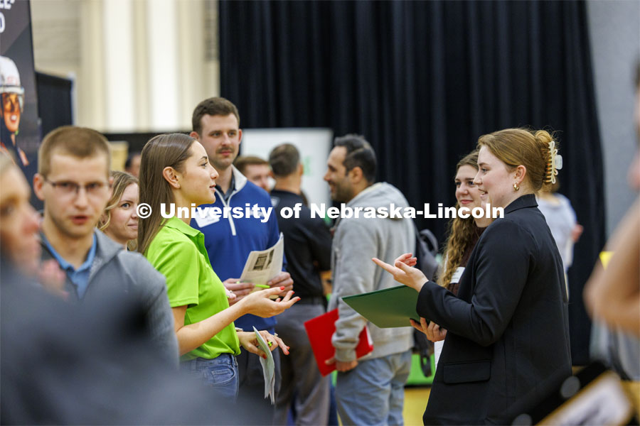 Evie Collier, right, a sophomore in mechanical engineering, talks with Tessa Yackley, a 2023 graduate in Civil Engineering who works for Olsson Engineering and also helps recruit. University Career + Internship Fair in the Nebraska Union. February 15, 2024. Photo by Craig Chandler / University Communication and Marketing.