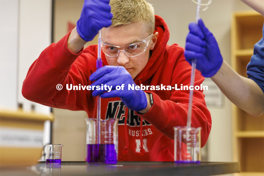 Brecken Krueger draws up crystal violet for a lab entitled “kinetics at work”. Hamilton Hall chemistry 110 lab. February 29, 2024. Photo by Craig Chandler / University Communication and Marketing.