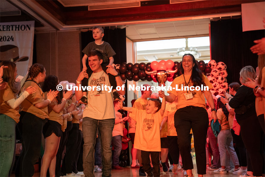 University of Nebraska-Lincoln student, Luke Woosley, enters with his miracle family at Dance Marathon. University of Nebraska–Lincoln students raised $83,702.24 during the annual HuskerThon. Also known as Dance Marathon, the event is part of a nationwide fundraiser supporting Children’s Miracle Network Hospitals. The annual event, which launched in 2006, is the largest student philanthropic event on campus. The mission of the event encourages participants to, “dance for those who can’t.” All funds collected by the Huskers benefit the Children’s Hospital and Medical Center in Omaha. March 2, 2024. Photo by Kirk Rangel.