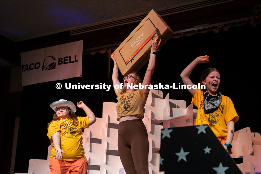 A University of Nebraska-Lincoln student raises up her prize of a new tv after competing in a dance off with two miracle kids at Dance Marathon. University of Nebraska–Lincoln students raised $83,702.24 during the annual HuskerThon. Also known as Dance Marathon, the event is part of a nationwide fundraiser supporting Children’s Miracle Network Hospitals. The annual event, which launched in 2006, is the largest student philanthropic event on campus. The mission of the event encourages participants to, “dance for those who can’t.” All funds collected by the Huskers benefit the Children’s Hospital and Medical Center in Omaha. March 2, 2024. Photo by Kirk Rangel.