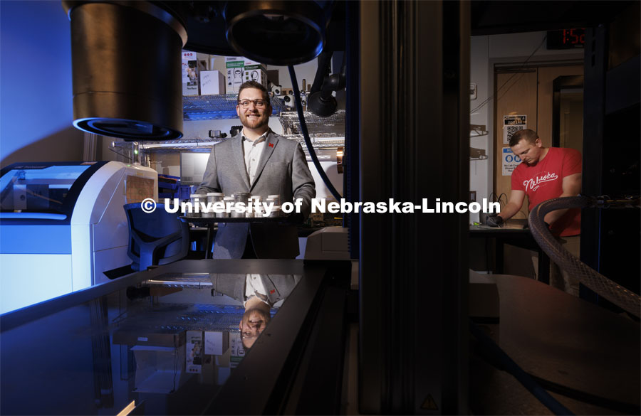 Eric Markvicka (left), Assistant Professor of Mechanical and Materials Engineering, holds a tray of liquid metal samples while graduate student Ethan Krings works on a sample at right. Markvicka has earned a CAREER award from the National Science Foundation to advance his work with room-temperature, non-toxic liquid metals. April 12, 2024. Photo by Craig Chandler / University Communication and Marketing.