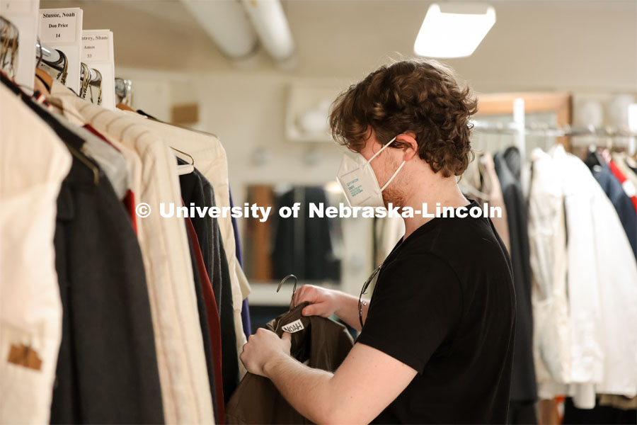 Hunter Rock organizes costumes for cast for the UNL production “Big Fish”. April 22, 2024. Photo by Taryn Hamill for University Communication and Marketing.