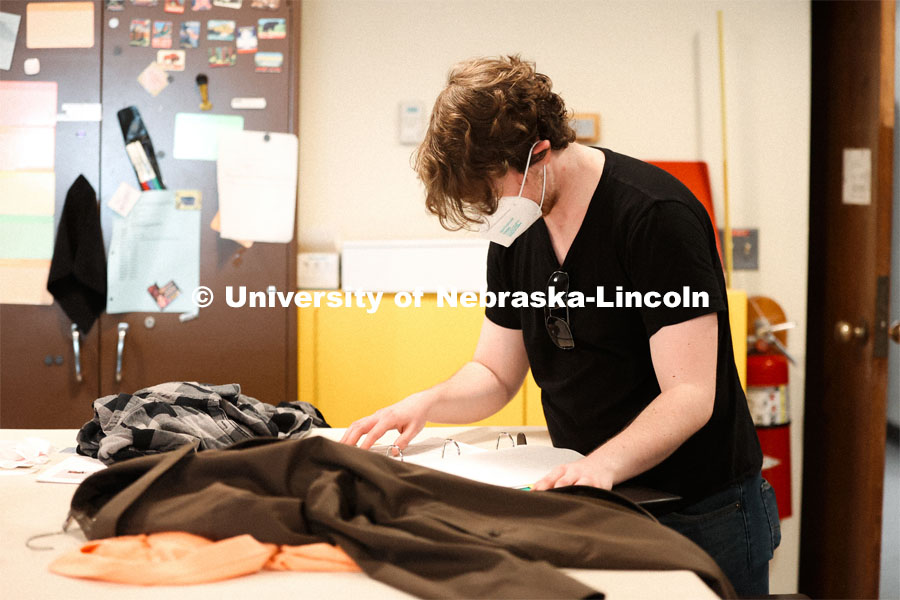 Hunter Rock organizes costumes for cast for the UNL production “Big Fish”. April 22, 2024. Photo by Taryn Hamill for University Communication and Marketing.
