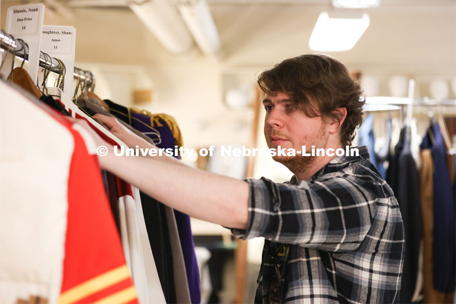 Hunter Rock organizes costumes for UNL’s production of “Big Fish”. April 23, 2024. Photo by Taryn Hamill for University Communication and Marketing.