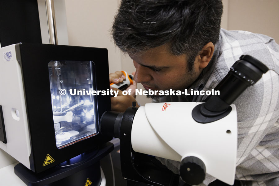 Eduardo Romero, Research Assistant Professor, loads a sample to be checked before being placed in the Cryo-Transmission Electron Microscope. CyroEM Core Facility in the Morrison Center on UNL’s East Campus. April 23, 2024. Photo by Craig Chandler / University Communication and Marketing.