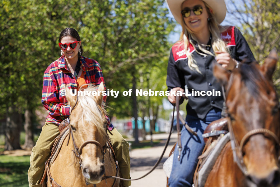 Alyssa Sturtevant rides a horse being led by Rodeo Club member Jadyn Fleischman. The Nebraska Rodeo Team gave Huskers a chance to be up close to their horses and even go for a ride. The team filled the space northwest of the Union to help promote their Nebraska Cornhusker College Rodeo being held Friday and Saturday. April 29, 2024. Photo by Craig Chandler / University Communication and Marketing.