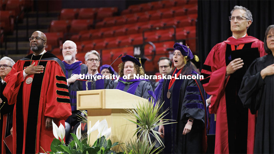 Professor Kristen Blankley performs the National Anthem. College of Law commencement in Devaney on the volleyball court. May 3, 2024. Photo by Craig Chandler / University Communication and Marketing.