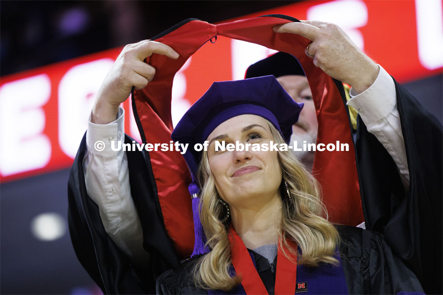 Lauren Kubat receives her hood. College of Law commencement in Devaney on the volleyball court. May 3, 2024. Photo by Craig Chandler / University Communication and Marketing.