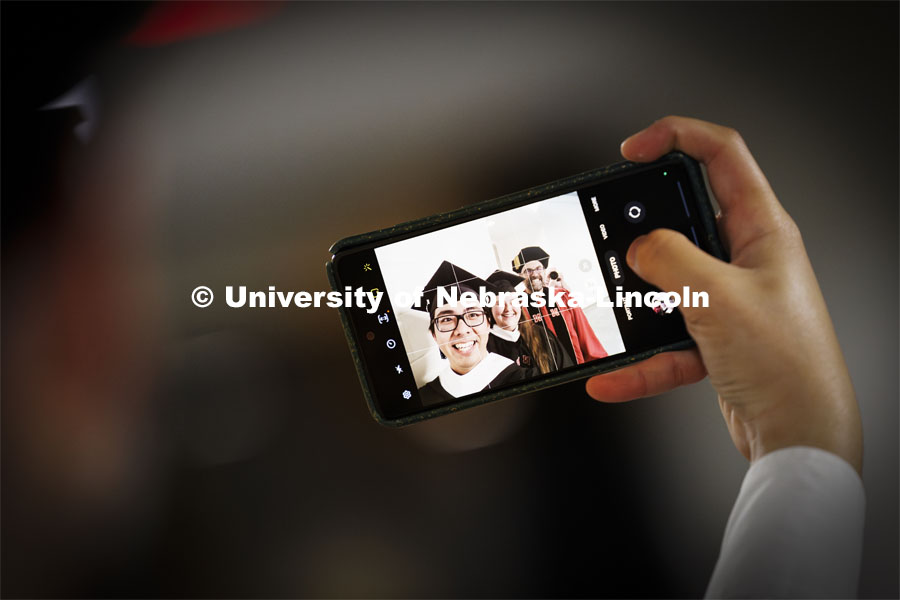 Jun Yi Goh takes a selfie with Joslyn Edmond and Alex Vazansky before the ceremony. Graduate Commencement. May 17, 2024. Photo by Craig Chandler / University Communication and Marketing.