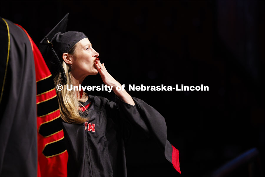 Lindsey Coleman blows a kiss to her family and friends. Graduate Commencement. May 17, 2024. Photo by Craig Chandler / University Communication and Marketing.