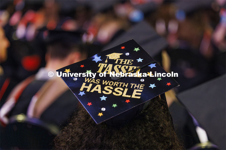 Bella Rodriguez lets the world know she’s proud of her master’s degree with her decorated mortarboard that reads “The tassel was worth the hassle”. Graduate Commencement. May 17, 2024. Photo by Craig Chandler / University Communication and Marketing.
