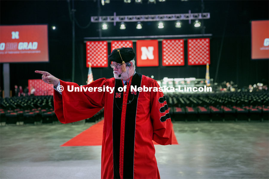 Dr. Robert Gorman points at the lineup of graduates to motion for them to come forward and begin the ceremony. May 17, 2024. Photo by Kristen Labadie / University Communication.