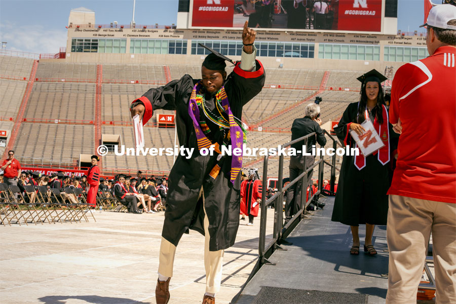 Gordon Taylor celebrates by doing a dance after receiving his diploma. Undergraduate Commencement in Memorial Stadium. May 18, 2024. Photo by Kristen Labadie / University Communication.