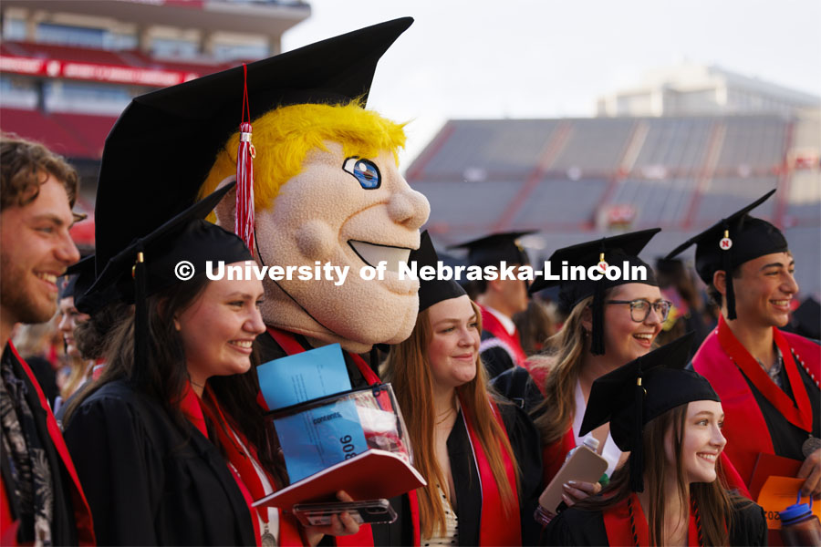 Herbie Husker poses with fellow graduates Saturday morning. Undergraduate Commencement in Memorial Stadium. May 18, 2024. Photo by Craig Chandler / University Communication and Marketing.