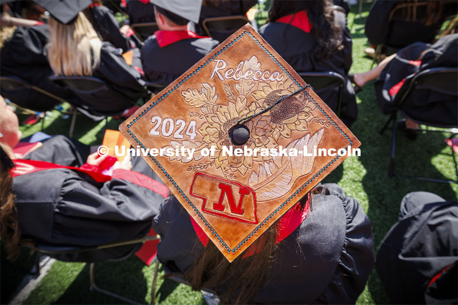 Rebecca Wulf wore a mortar board decorated with embossed leather. Undergraduate Commencement in Memorial Stadium. May 18, 2024. Photo by Craig Chandler / University Communication and Marketing.