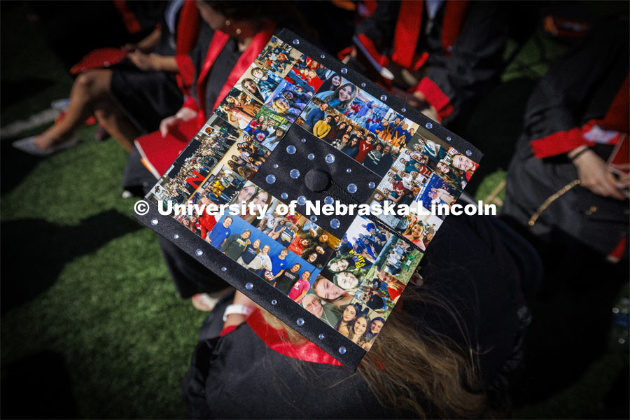 Mackenzi Berglund decorated her mortar board with photos of family and friends. Undergraduate Commencement in Memorial Stadium. May 18, 2024. Photo by Craig Chandler / University Communication and Marketing.