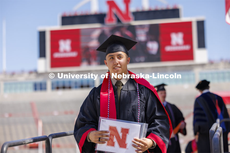 Daniel Do, an Economics major in the College of Arts and Sciences and an US Army second lieutenant after being in the UNL ROTC program, walks off the stage. Undergraduate Commencement in Memorial Stadium. May 18, 2024. Photo by Craig Chandler / University Communication and Marketing.