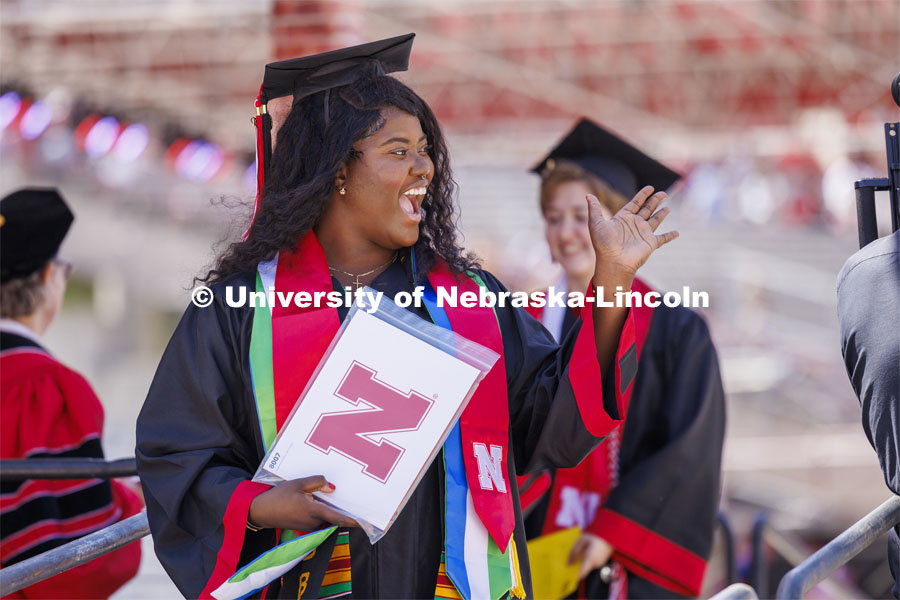 Nyawa Allieu waves to friends after receiving her Engineering degree. Undergraduate Commencement in Memorial Stadium. May 18, 2024. Photo by Craig Chandler / University Communication and Marketing.