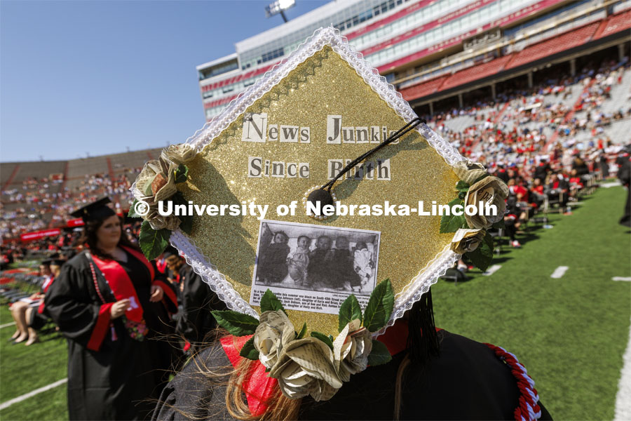 Alyssa Huber was featured in the Lincoln Journal Star as a newborn and will now work for the newspaper after graduating with her journalism degree. Huber’s mortar board is decorated with newsprint flowers, a photo and cutout letters from a newspaper. Undergraduate Commencement in Memorial Stadium. May 18, 2024. Photo by Craig Chandler / University Communication and Marketing.