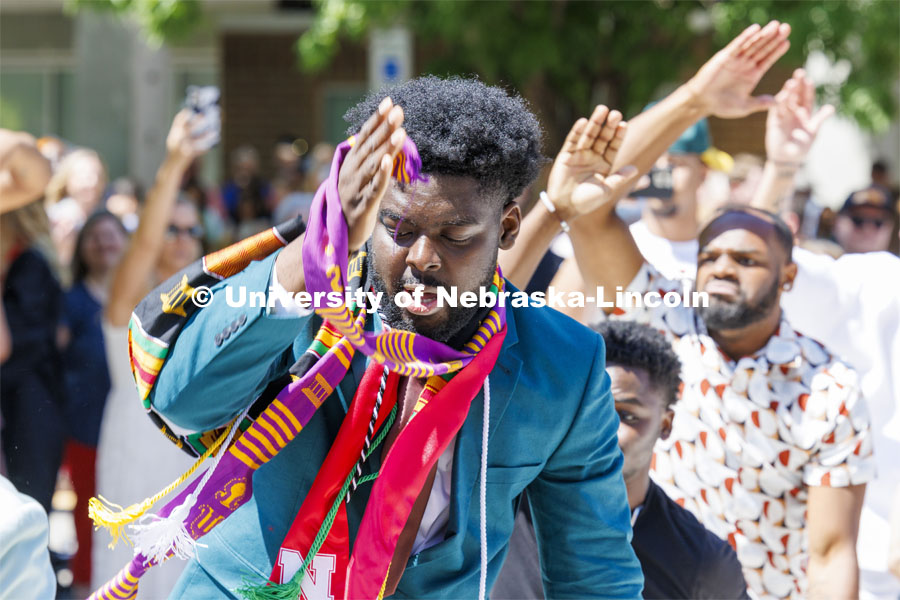Wil Koumaka celebrates graduation by dancing with Omega Psi Phi fraternity brothers outside Memorial Stadium. Undergraduate Commencement in Memorial Stadium. May 18, 2024. Photo by Craig Chandler / University Communication and Marketing.