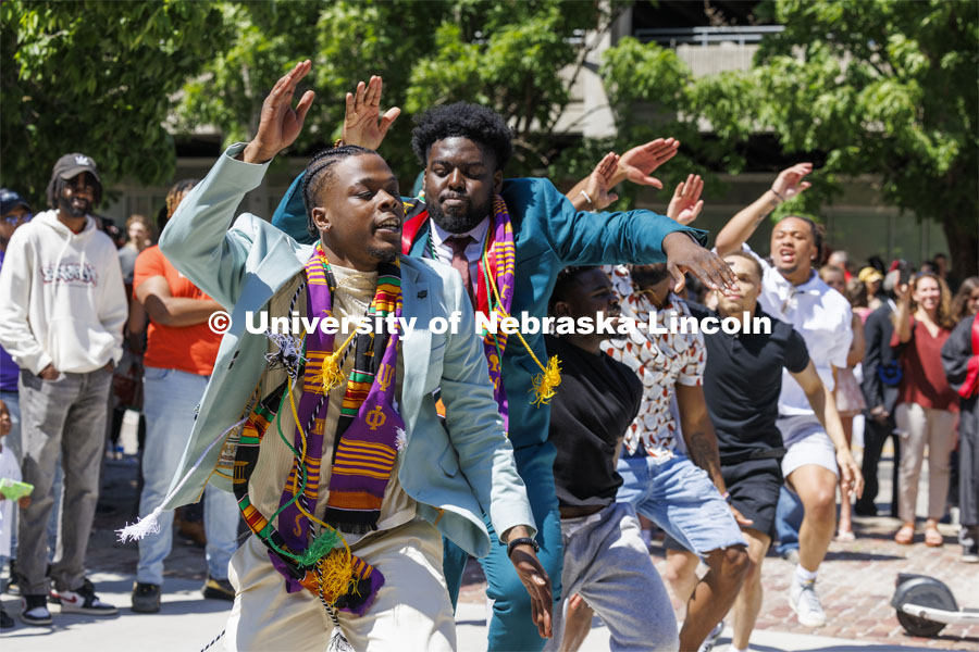 Gordon Taylor and Wil Koumaka celebrate their graduation by dancing with their Omega Psi Phi fraternity brothers outside Memorial Stadium. Undergraduate Commencement in Memorial Stadium. May 18, 2024. Photo by Craig Chandler / University Communication and Marketing.